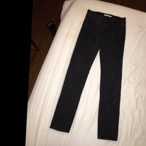 Black low rise Levi’s pants.